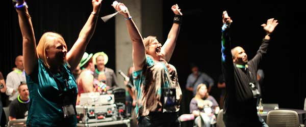 Attendees with hands in the air