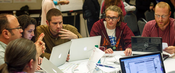 web professionals collaborating around a table
